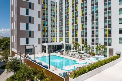 an aerial view of a building with a swimming pool at Aloft Miami Aventura in Aventura