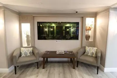 a living room with two chairs and a table at Quality Inn Miami Airport - Doral in Miami