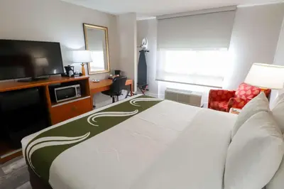 a hotel room with a bed and a flat screen tv at Quality Inn Miami Airport - Doral in Miami