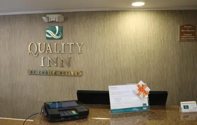 a counter with a phone and a sign on it at Quality Inn Miami Airport - Doral in Miami