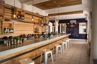 a restaurant with a bar with stools at Broadmore Miami Beach in Miami Beach