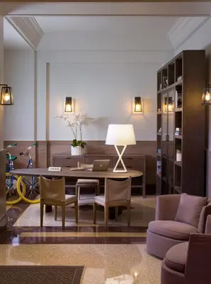 a living room with a table and chairs at Hotel Victor South Beach in Miami Beach