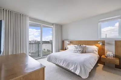 a bedroom with a large bed and a large window at 1201 W Residences in Fort Lauderdale