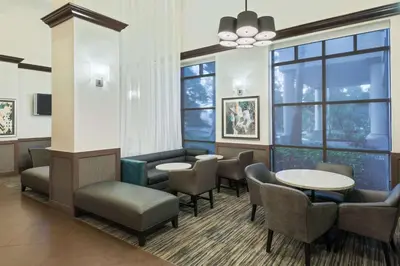 a waiting room with chairs and tables and windows at Hyatt Place Ft. Lauderdale/Plantation in Plantation
