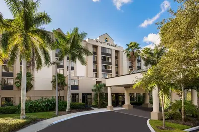 a hotel with palm trees in front of it at Hyatt Place Ft. Lauderdale/Plantation in Plantation