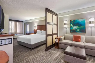 a hotel room with a bed and a couch at Hyatt Place Ft. Lauderdale/Plantation in Plantation