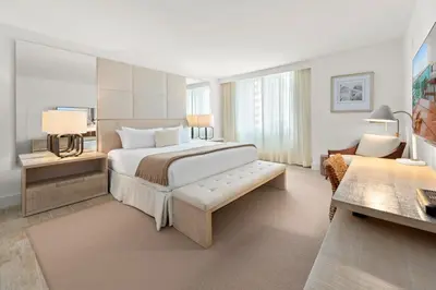 a bedroom with a large bed and a living room at Oceanview Private Condo at 1 Hotel & Homes -915 in Miami Beach
