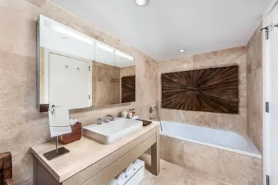 a bathroom with a sink and a large mirror at Oceanview Private Condo at 1 Hotel & Homes -1208 in Miami Beach
