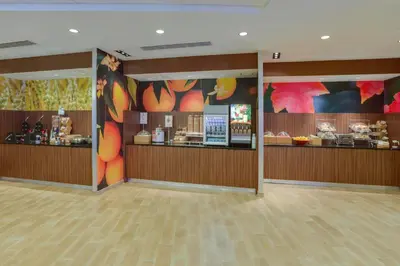 a restaurant with a counter with food on it at Fairfield Inn & Suites By Marriott Fort Lauderdale Downtown/Las Olas in Fort Lauderdale