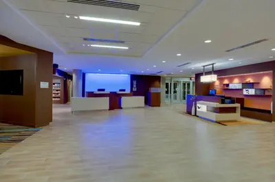a lobby with a large room with a large screen at Fairfield Inn & Suites By Marriott Fort Lauderdale Downtown/Las Olas in Fort Lauderdale