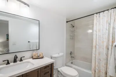 a bathroom with a toilet and a sink and a tub at Sunny Isles Ocean Reserve Superb Condo Apartments in Miami Beach