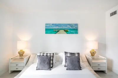 a bedroom with a bed with two night stands and two lamps at Sunny Isles Ocean Reserve Superb Condo Apartments in Miami Beach