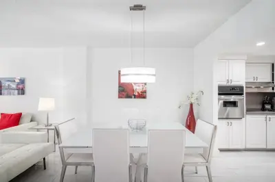 a white living room with a white table and chairs at Sunny Isles Ocean Reserve Superb Condo Apartments in Miami Beach