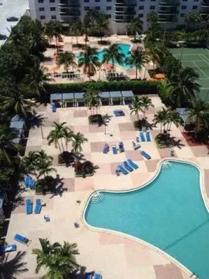 an aerial view of a resort with a swimming pool at Sunny Isles Ocean Reserve Condo Apartments in Miami Beach