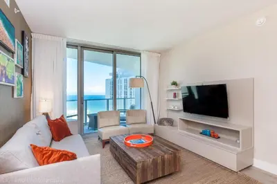 a living room with a couch and a tv at 2 Bedroom on 17th floor on the beach Resort in Hallandale Beach