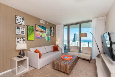 a living room with a couch and a tv at 2 Bedroom on 17th floor on the beach Resort in Hallandale Beach