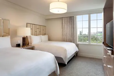 a hotel room with two beds and a window at JW Marriott Miami Turnberry Resort & Spa in Aventura