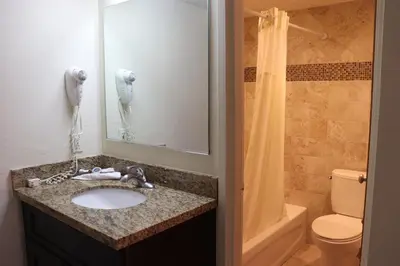 a bathroom with a sink and a toilet and a shower at Curtis Inn & Suites in Hollywood