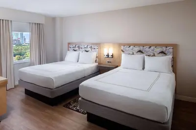 a hotel room with two beds and a window at Hampton Inn & Suites by Hilton Miami Downtown/Brickell in Miami