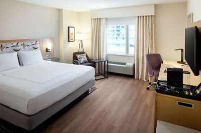 a hotel room with a bed and a desk and a television at Hampton Inn & Suites by Hilton Miami Downtown/Brickell in Miami