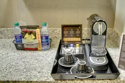 a kitchen counter with a coffee maker and soda bottles at Hampton Inn & Suites by Hilton Miami Downtown/Brickell in Miami