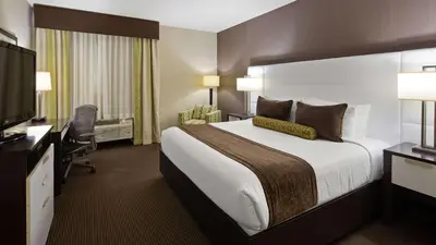 a hotel room with a large bed and a television at Best Western Plus Miami Intl Airport Hotel & Suites Coral Gables in Miami