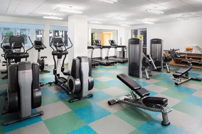 a gym with several treadmills and cardio machines at Element Miami International Airport in Miami