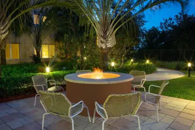 a patio with a table and chairs and a fountain at Element Miami International Airport in Miami
