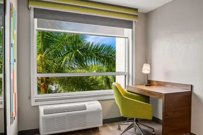 a window in a room with a desk and a green chair at Hampton Inn Weston Fort Lauderdale in Weston
