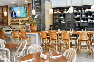 a restaurant with tables and chairs and a bar at Boulan South Beach in Miami Beach