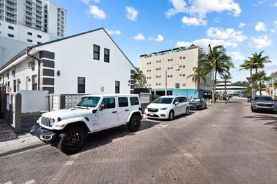 a white jeep parked on the side of a street at Modern Loft wQueen Loft Steps to Beach in Hollywood