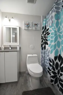 a bathroom with a toilet and a sink at Modern Loft wQueen Loft Steps to Beach in Hollywood