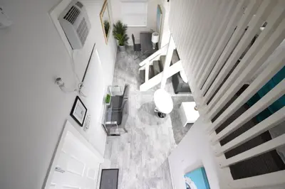 an overhead view of a hallway in a house at Lofted Apt wQueen Loft Nook steps to Beach in Hollywood