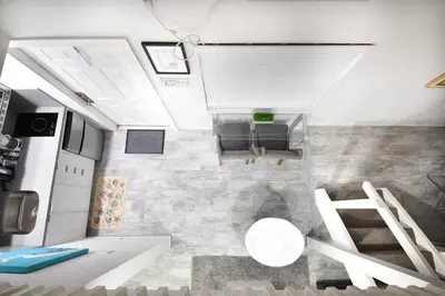 a view of a kitchen and living room in a tiny house at Lofted Apt wQueen Loft Nook steps to Beach in Hollywood