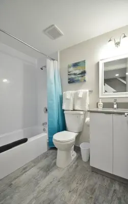 a bathroom with a toilet and a tub and a sink at Lofted Apt wQueen Loft Nook steps to Beach in Hollywood
