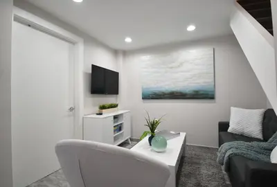 a living room with a couch and a table at Loft wqueen loft beach steps in Hollywood