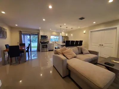 a living room with a couch and a table at Lakefront Vacation Home - Sleeps 8 in Davie