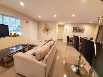 a living room with a couch and a dining room at Lakefront Vacation Home - Sleeps 8 in Davie