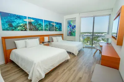 a hotel room with two beds and an ocean view at Maritime Hotel Fort Lauderdale Airport & Cruiseport in Fort Lauderdale
