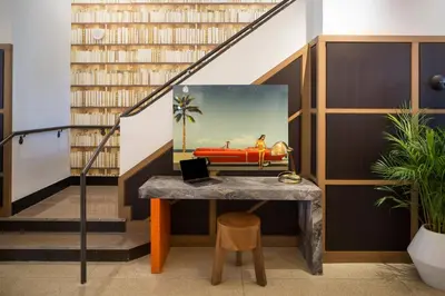 a table in a room with bookshelves at Generator Miami in Miami Beach