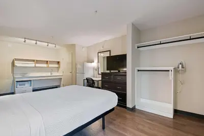 a hotel room with a bed and a kitchen at Extended Stay America Suites - Miami - Airport - Blue Lagoon in Miami