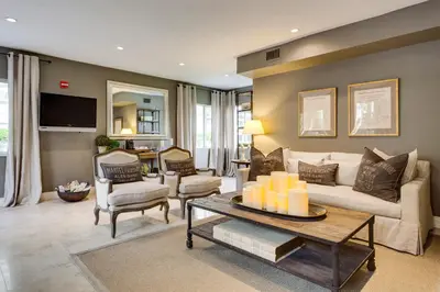 a living room with a couch and a table at Sun Harbour Boutique Hotel in Miami Beach