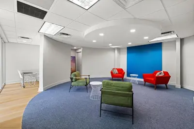 a waiting room with chairs and a table at Signature Inn Miami in Miami