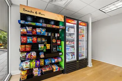 a grocery store with a refrigerator and food at Signature Inn Miami in Miami
