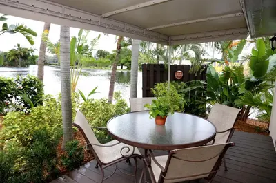 a man sitting at a table on a patio at The Cabanas Guesthouse & Spa - Gay Resort catering to Gay Men in Fort Lauderdale