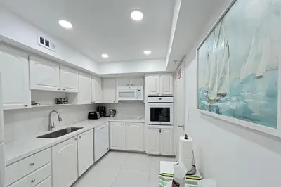 a white kitchen with white cabinets and a sink at THE TIDES 1bedroom apt 15th floor WE ARE ON THE BEACH! in Hollywood