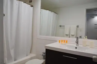 a bathroom with a sink and a toilet and a shower at New Point Miami Beach Apartments in Miami Beach