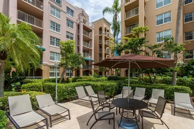 a patio with a table and chairs and an umbrella at Yacht Club at Aventura 1 Bd 1 Bth Brand New in Aventura
