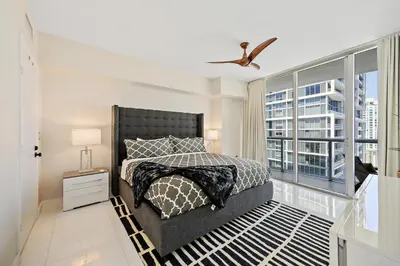 a bedroom with a bed and a large window at Icon Brickell Residences in Miami