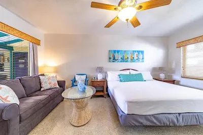 a living room with a bed and a couch at The Desoto - Oceanview Inn in Hollywood